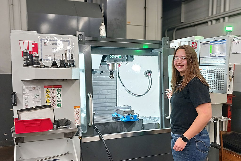 Ntm Employees Working On Machine Components