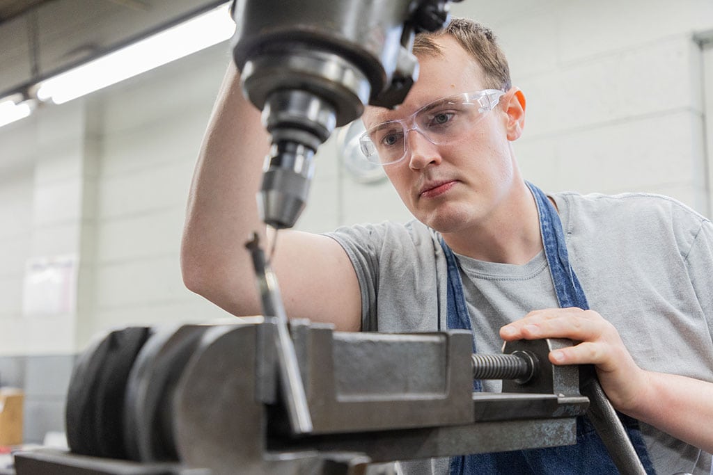 R61_5691 Ntm Employee Working On Machine Components